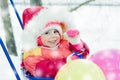 Toddler winter sledding with balloons. Royalty Free Stock Photo