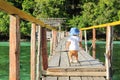 Toddler on wooden jetty and shack on tourist place