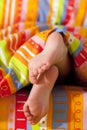 Toddlers girl feet in a bed under the morning sun Royalty Free Stock Photo