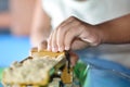 Toddlers are playing sand trucks and yellow excavators