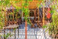 A restaurant courtyard seen through a metal fence