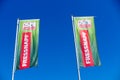 TOENISVORST, GERMANY - JUIN 28. 2019: Close up of isolated red and green flags against blue sky of Fressnapf german supermarket