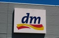 TOENISVORST, GERMANY - JUIN 28. 2019: Close up of logo of DM store on metal wall with blue sky german drugstore chain