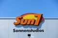 TOENISVORST, GERMANY - JUIN 28. 2019: Close up of orange and yellow logo of sun7 german tanning salon chain on wall against blue