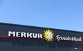 TOENISVORST, GERMANY - JUIN 28. 2019: Close up of text and sun logo Merkur Spielothek german gambling hall chain with blue sky