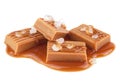 Toffee candies with caramel sauce and sea salt isolated on white background. Golden Butterscotch toffee caramels Royalty Free Stock Photo