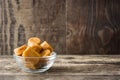 Toffee caramel candies in a crystal bowl on wood Royalty Free Stock Photo