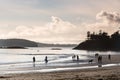 Surfers and walkers at McKenzie Beach at sunset, Pacific Rim National Park Reserve, Vancouver Island