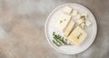 Tofu cheese slices on a light background. Non diary vegan cheese substitute alternative. Long banner format. top view
