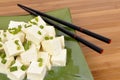 Asian vegetarian food : Tofu cubes with chopsticks close up Royalty Free Stock Photo