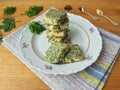 Tofu in green goutweed tempura on plate, cooking organic food