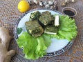 Tofu in green nettles tempura, on a plate with lettuce