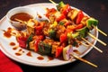 tofu skewers with mixed vegetables and spicy sriracha sauce on a paper plate Royalty Free Stock Photo