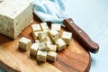 Tofu sliced on a wooden board.