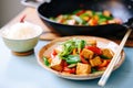 tofu stir fry with mixed bell peppers on wok Royalty Free Stock Photo