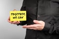 Together We Can. Businessman with a paper card in his hands Royalty Free Stock Photo