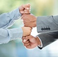 Together we can go higher. two unrecognizable businesspeople standing with their fists stacked in the office.