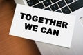 TOGETHER WE CAN inscription on white paper note on laptop keyboard. Closeup Royalty Free Stock Photo
