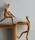 Together Concept, Wooden Human Help Another, Hand Touching With Helping Action on Background, Royalty Free Stock Photo