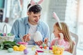 Together with dad we will paint a big Easter egg.Dad and his little daughter together have fun while preparing for Easter holidays Royalty Free Stock Photo