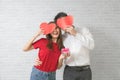 Together forever. Portrait of positive romantic couple man hug paper heart his sweetheart woman