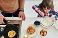 Together we making scrumptious pancakes. High angle shot of an adorable little boy making pancakes with his