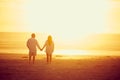 Together in paradise. Rearview shot of an affectionate mature couple walking hand in hand on the beach. Royalty Free Stock Photo