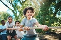 Together a team achieves more. a group of teenagers playing a game of tug of war at summer camp. Royalty Free Stock Photo