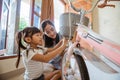 Togetherness of mother and daughter installing a basket