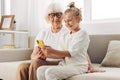 Togetherness smiling education phone sofa granddaughter hugging selfie bonding grandmother child family Royalty Free Stock Photo