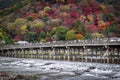 Togetsukyo Bridge in autumn, many people cross it