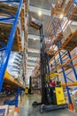 Large modern LADA-IMAGE warehouse with forklifts for storage vehicle spare parts.