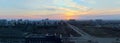 Panorama of the city overlooking the intersection of Yubileinaya and Frunze streets against the sunset sky and clouds.