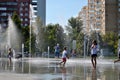 Children play with jets of a fountain on a hot sunny afternoon in the park of the 50th anniversary of JSC AvtoVAZ. Royalty Free Stock Photo