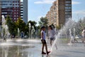 Children play with jets of a fountain on a hot sunny afternoon in the park of the 50th anniversary of JSC AvtoVAZ. Royalty Free Stock Photo