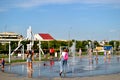 Children play with jets of a fountain on a hot sunny afternoon in the park of the 50th anniversary of JSC AvtoVAZ. Royalty Free Stock Photo