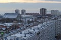 Panoramic view of snow-covered residential buildings and the building of the Olimp sports complex.