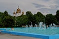 View of the fountain in Zhilkin square on a hot sunny day and children bathing in it.