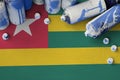 Togo flag and few used aerosol spray cans for graffiti painting. Street art culture concept