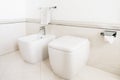 Toilet and bidet in a modern bathroom - lid closed. Royalty Free Stock Photo