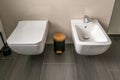 Modern equipment in a new bathroom with toilet and bidet next to it Royalty Free Stock Photo