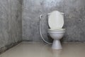 Toilet bowl with bidet shower in toilet. Royalty Free Stock Photo
