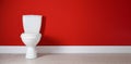 Toilet bowl near red wall in restroom. Banner design Royalty Free Stock Photo