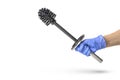 Toilet brush in hand on a white isolated background, a hand in a blue rubber glove holds a black chrome toilet brush. Royalty Free Stock Photo