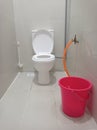 Toilet with bucket,brush and water pipe