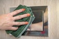 Toilet button cleaning. Woman cleaning toilet flush button with green microfiber cloth. Cleaning the bathroom or toilet. Royalty Free Stock Photo