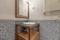 Toilet with cherry wood cabinet with glass top, wall radiator