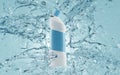 Toilet cleaner bottle in water splash. Detergent product bathroom cleaning ad, liquid bleach. White container Royalty Free Stock Photo