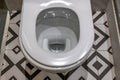 Toilet close up, water flushing in toilet, A photo of a white ceramic toilet bowl. White toilet bowl in a bathroom Royalty Free Stock Photo
