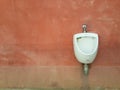 Toilet on wall orange background
